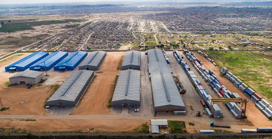 Aerial view of BAK warehouses beside a rail siding.