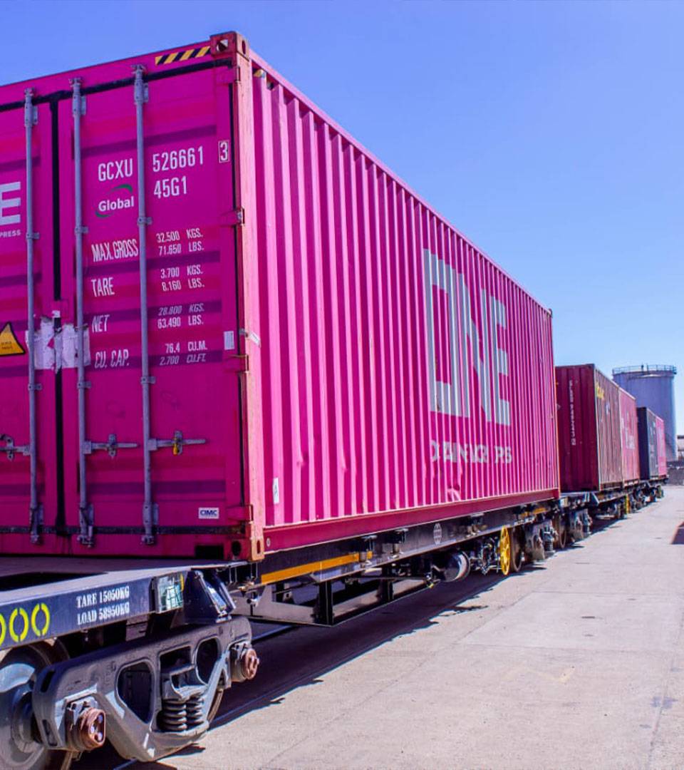 Containers loaded on a line of rail wagons.